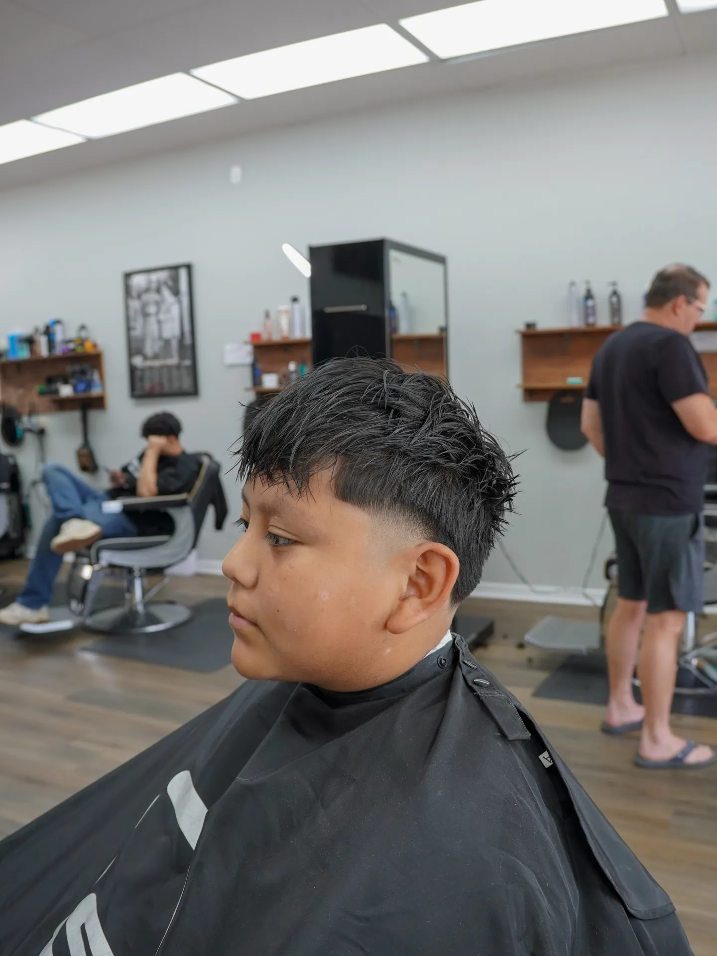 Boy with a textured top and a drop fade, side profile