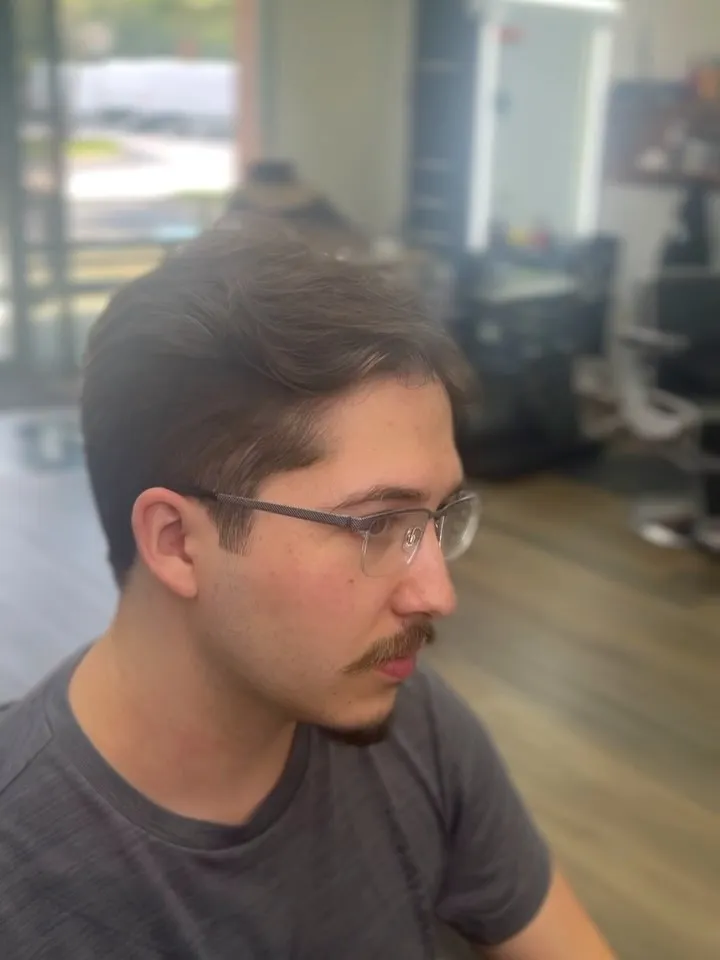 Middle part with a low taper and glasses, side profile