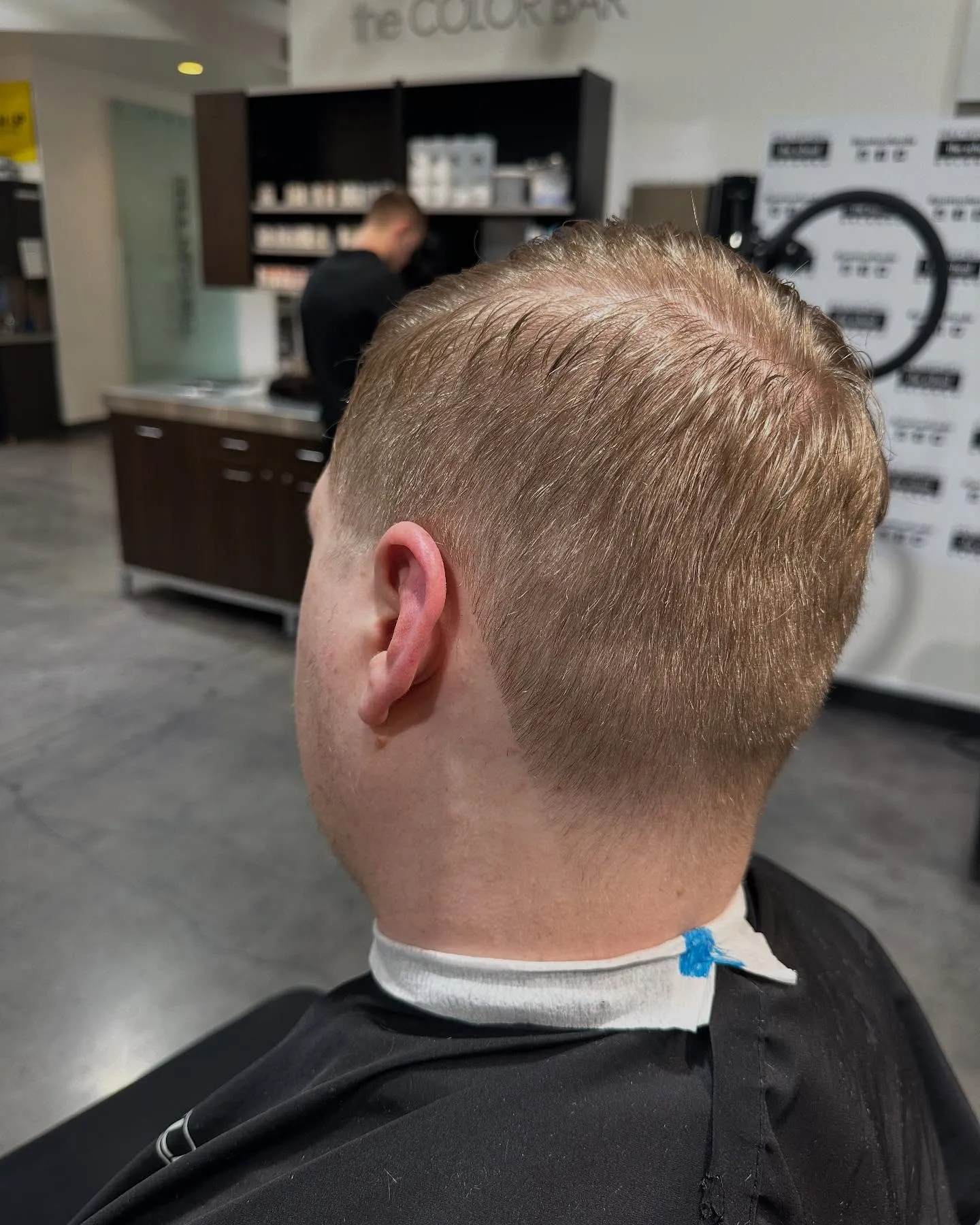Back view of a clean taper on short blond hair